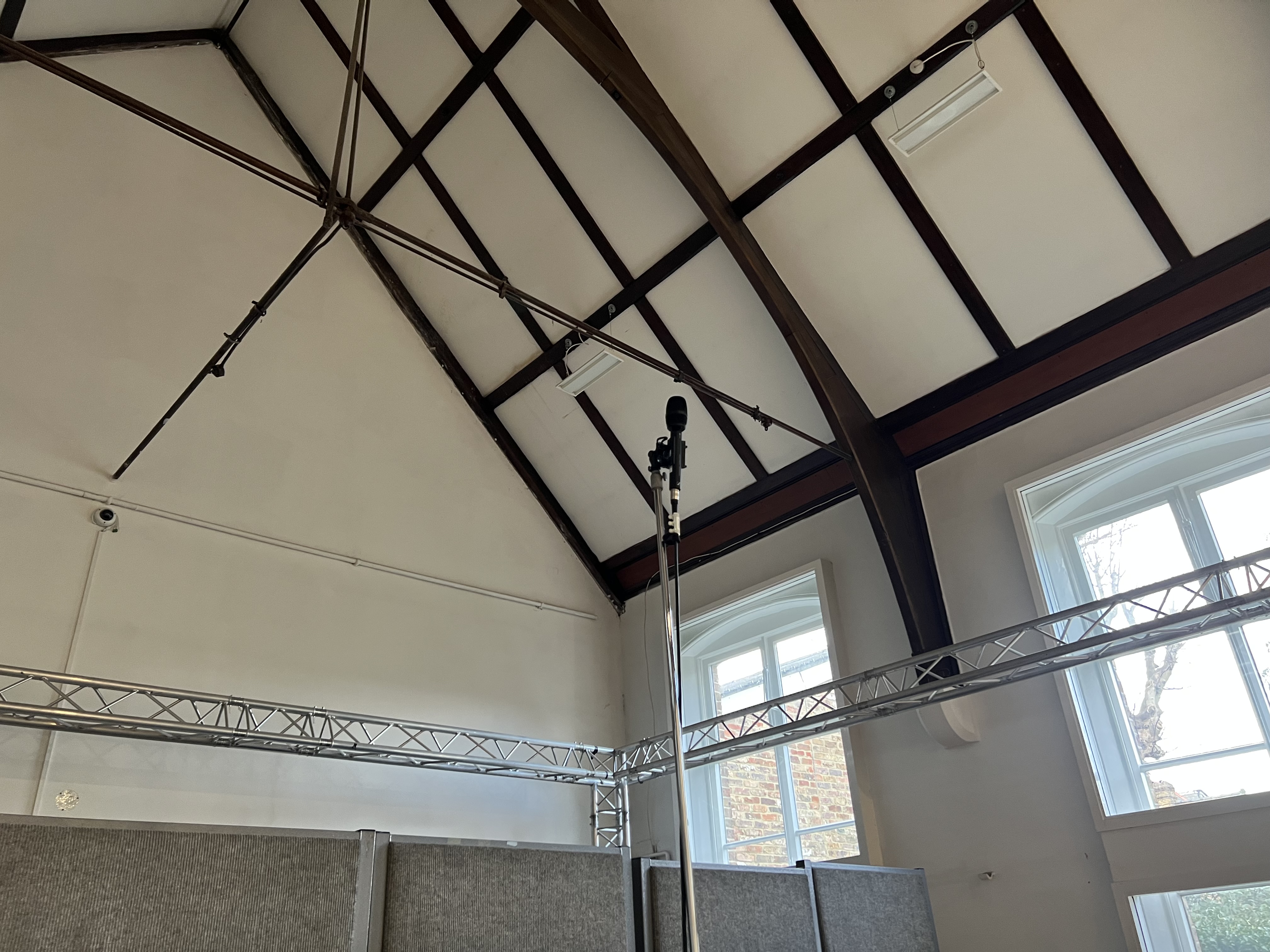 An ambisonics microphone mounted high up into the room.